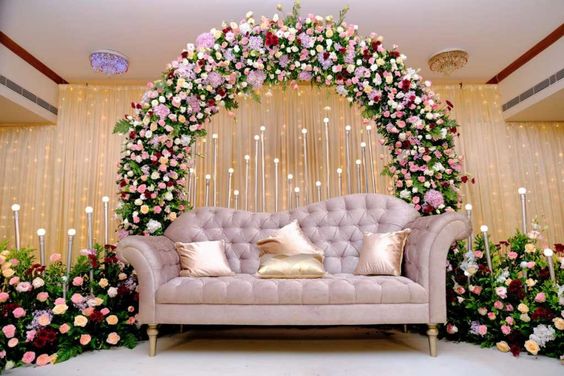 Decorate the stage with mixed flowers and a golden stand
