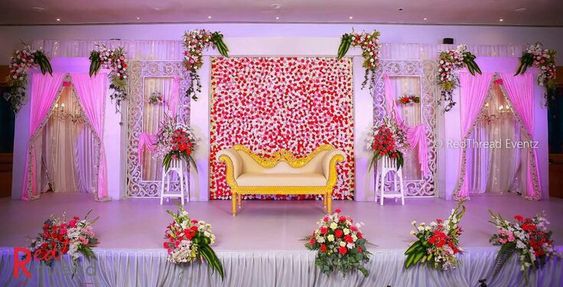 A red-and-white wall with a flower bouquet made up of a variety of flowers