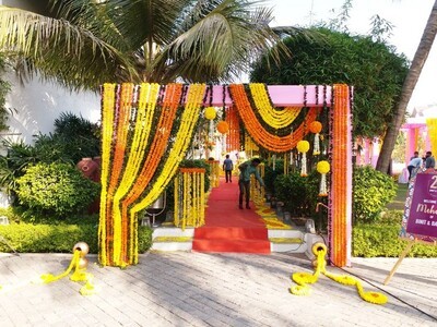 Marigold Flower Entry Surprise your guests with some out-of-the-box ideas for adorning your wedding venue entry point with some amazing genda phool décor. Let's get rid of the traditional marigold flower arrangement and replace it with a marigold tree, a flower fountain, and a marigold tree.