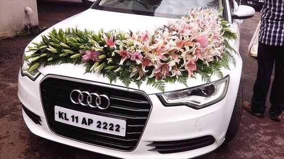 wedding car decoration with flowers on white car
