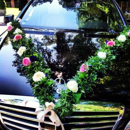 wedding car decoration with flowers on black car